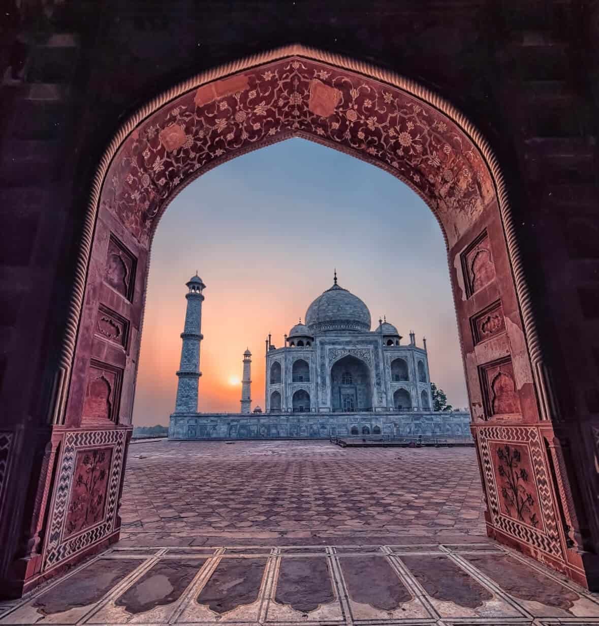 Visitors walking toward the Taj Mahal at midday